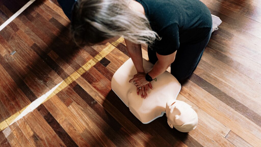 Learner practising CPR on a manikin