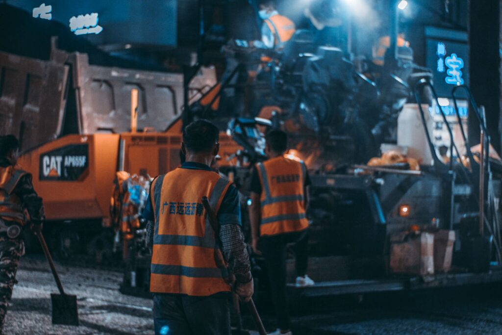 Road workers in hi-vis at a night worksite