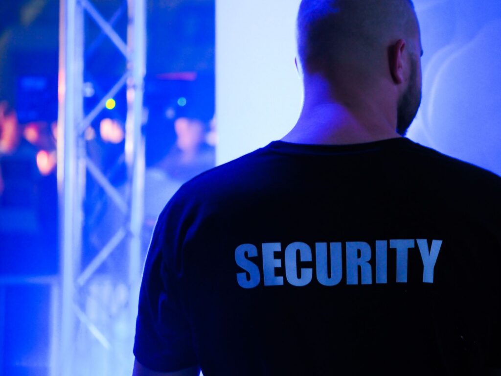Security officer wearing a SECURITY shirt at a venue